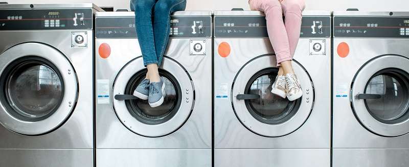 Women,Sitting,On,The,Washing,Machines,Waiting,For,The,Washing